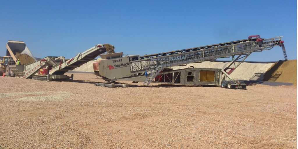 Titan 450-5T Bulk Reception Feeder and TS 42 Telescopic Stacker in a Heap Leaching application in Namibia processing at up to 500TPH from 35 Tonne Volvo ADT Mine Trucks. Image: Telestack